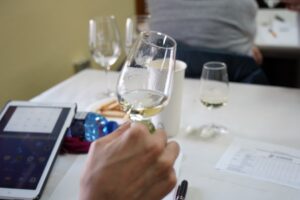 Una catadora observa una muestra de vino blanco